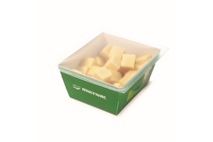 Image Multivac's packaging for cheese in a green paperboard tray.